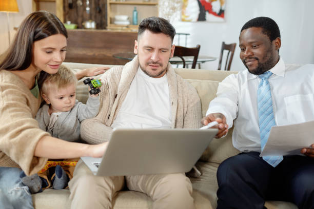 ethnic consultant discussing real estate with young family - family insurance agent real estate financial advisor imagens e fotografias de stock