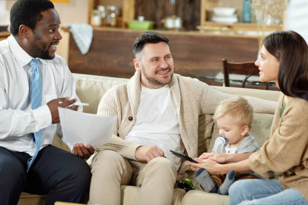 istock Young family with financial consultant at home 1203391663