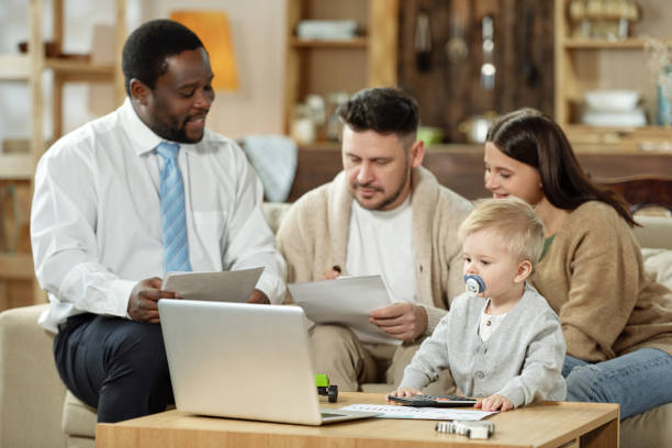 istock Couple with kid having meeting with adviser 1203391671