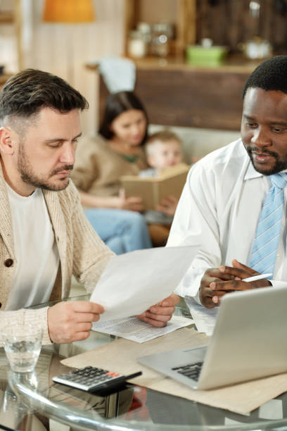 istock Adult men discussing home loan at table 1203391757
