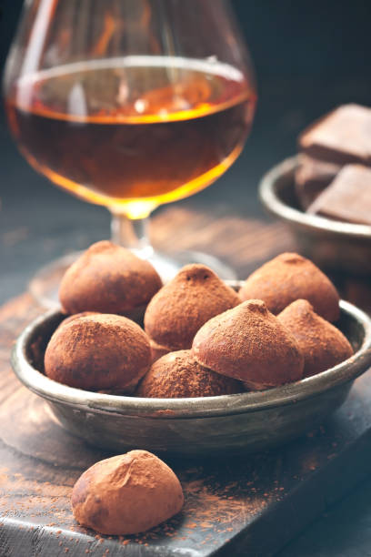 istock Composition with  chocolates truffles  and brandy glass 1203392724