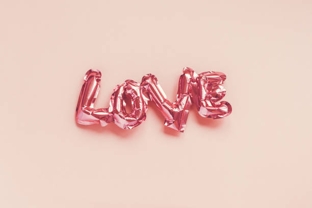 istock Love concept. Inflatable pink balloon with letters 1203394463