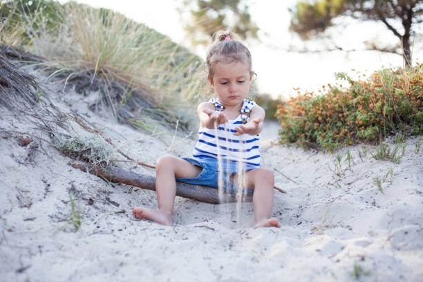 istock cute girl playing at the beach 1203395171