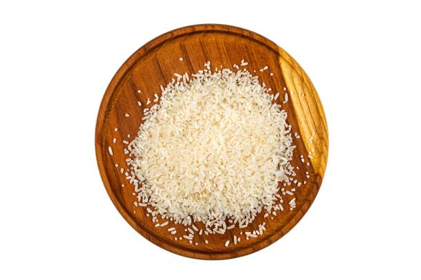 istock Raw white rice of poor quality on white background 1203395278