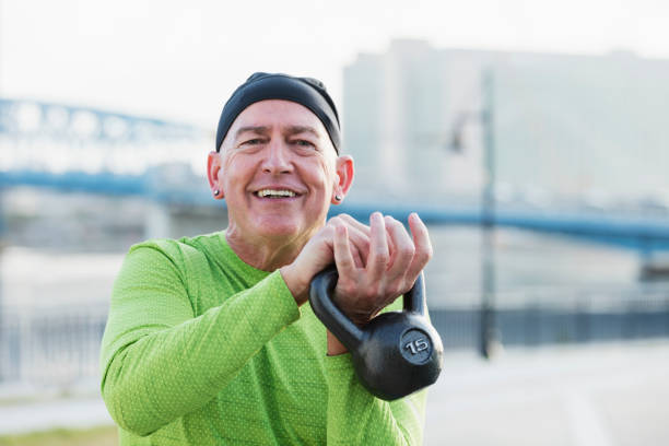 istock Mature man in city, exercising with kettlebell 1203397836