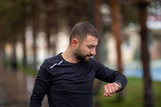 istock Sportsman looking at his smart watch 1203399046