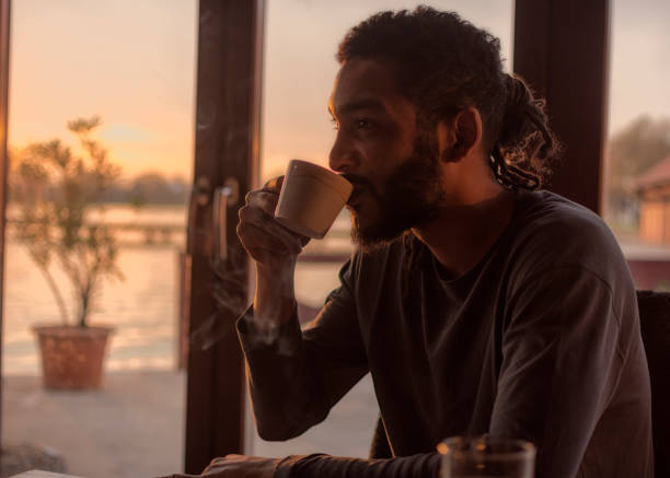 istock African man starting the day with black coffee and cigarette 1203399851