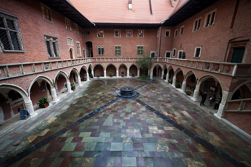 Krakow, Poland - September 24, 2018: Collegium Maius arcade courtyard, oldest building of Jagiellonian University, 15th century Gothic architecture