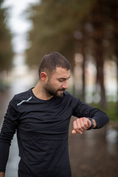 istock Sportsman looking at his smart watch 1203400207