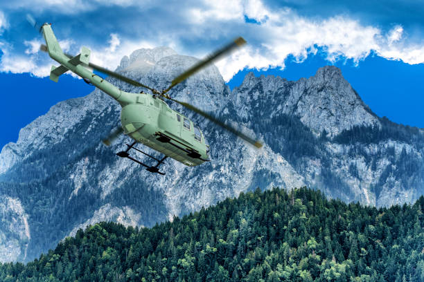 istock Green helicopter on background of high Alps mountains. 1203403745