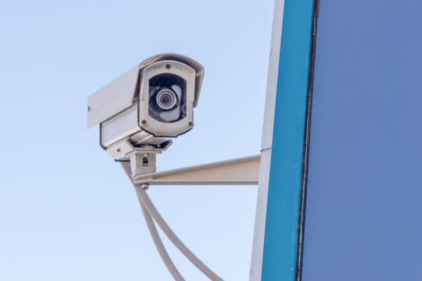istock outdoor surveillance camera against the blue sky 1203403978
