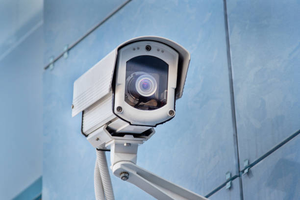 istock outdoor surveillance camera on the blue wall 1203403984