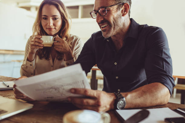 istock Two business colleagues working at coffee shop 1203413711