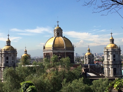 Skyline view of steeples in foreground and Mexico City in background at Tepeyac Hill.