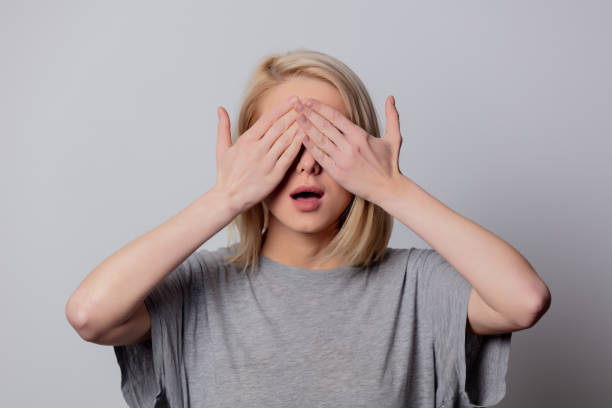 istock serious blonde woman in glasses on white background 1203417087