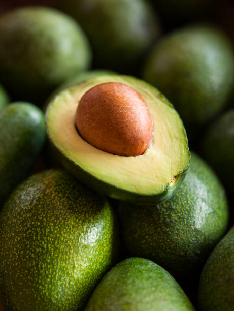 close up view of halves of an avocado - avocado imagens e fotografias de stock