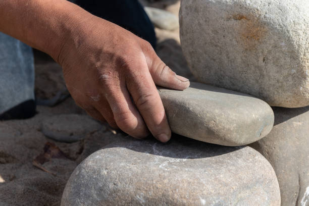 istock Hands of a craftsman engineering with stone. 1203420090