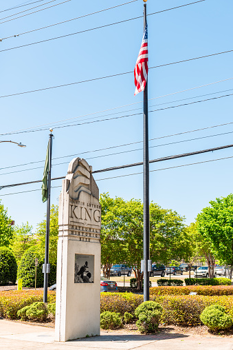 Atlanta, USA - April 20, 2018: Sign for Martin Luther King Jr National historic site in Georgia city in summer with park view and american flag