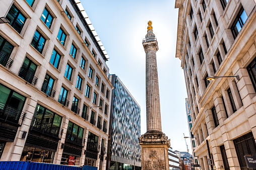 London, UK - June 26, 2018: Column monument to the Great Fire of London street road in center of downtown financial district city old architecture