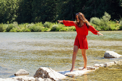 a young woman is having fun on the isar river in munich