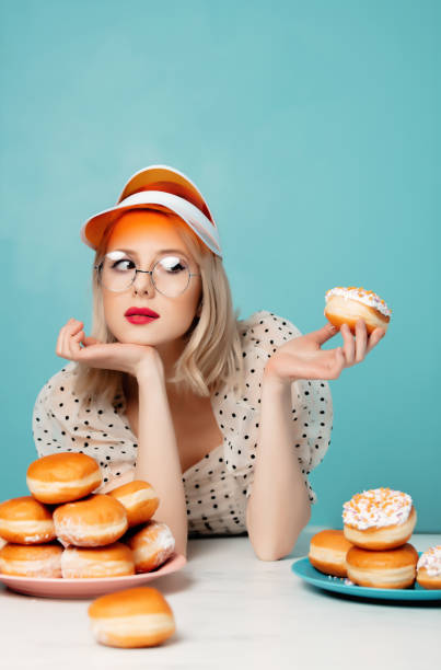 istock Beautiful woman in 90s clothes with donuts 1203427177
