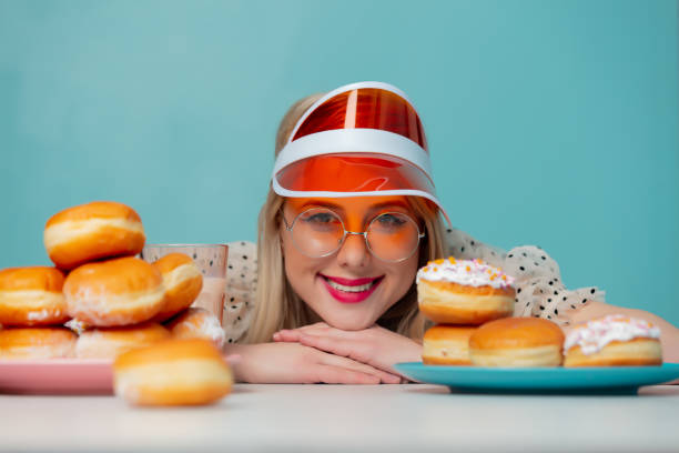 istock Beautiful woman in 90s clothes with donuts 1203427278