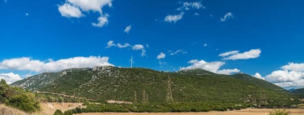 istock Windmills on green hills of central Greece 1203430441
