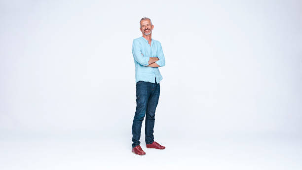 istock Senior man standing with arms crossed 1203432557