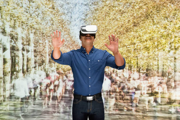 istock Young male in blurred motion who is outdoors and using virtual reality simulator 1203435124