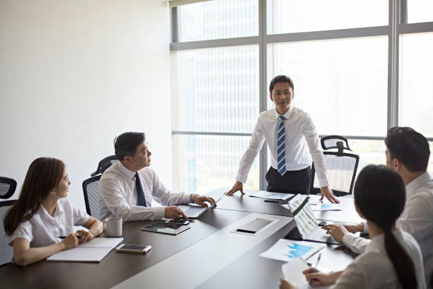 istock Chinese Corporate Team Listening to Presentation 1203435411