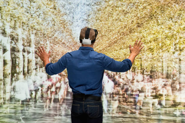 istock Young male in blurred motion who is outdoors and using virtual reality 1203436072