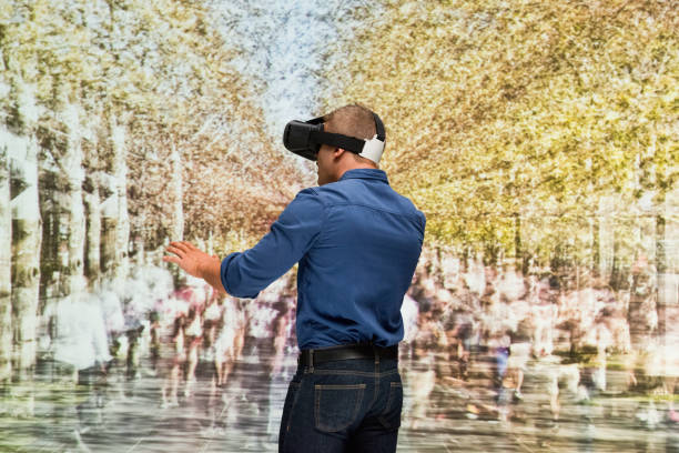 istock Young male in blurred motion who is outdoors and using virtual reality simulator 1203436311