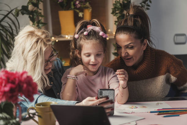 istock Couple with a kid using a mobile phone 1203440166