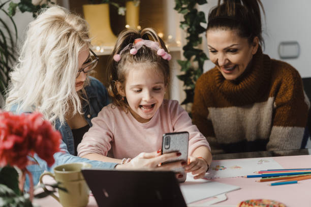 istock Couple with a kid using a mobile phone 1203440183