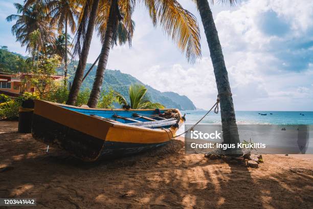 Colorful Fishing Boat Near The Transparent And Clear Turquoise Water On A Remote Paradise Island Stock Photo - Download Image Now