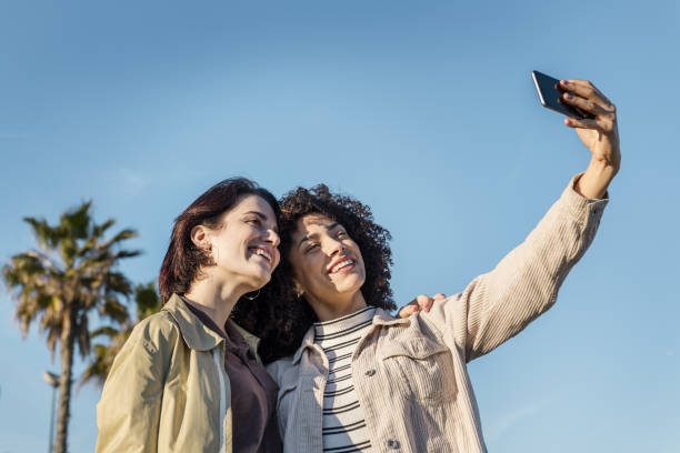 istock two girls taking selfie with a mobile phone 1203441830