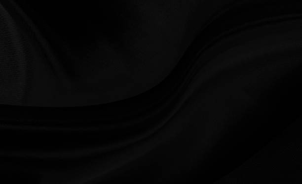 istock Black gray satin dark fabric texture luxurious shiny that is abstract silk cloth background with patterns soft waves blur beautiful. 1203444730