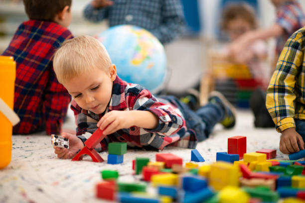 istock Little Blond Boy Building with Blocks stock photo 1203446152