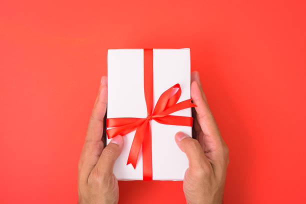 istock Valentine's Day Concept, Top view Flat lay, Hand holding gift box on red background 1203448363