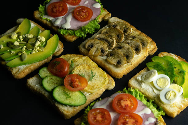 istock Combination with different kinds of sandwiches: with mushrooms, with avocado and eggs, with ham 1203451657