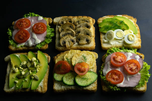 istock Combination with different kinds of sandwiches: with mushrooms, with avocado and eggs, with ham 1203451663