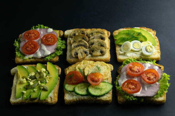 istock Combination with different kinds of sandwiches: with mushrooms, with avocado and eggs, with ham 1203451671