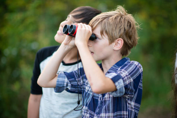 istock Two Youth Bird Watching With Binoculars stock photo 1203460160