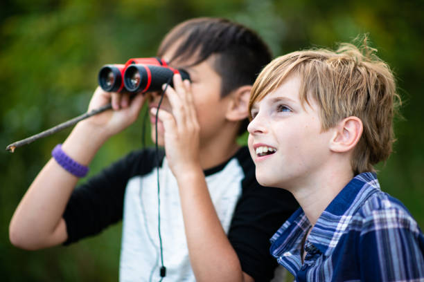 istock Two Youth Bird Watching With Binoculars stock photo 1203460190