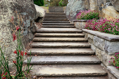 Staircase through a rock cutting in a large garden.