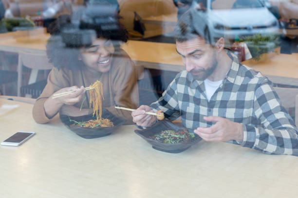 istock Happy young couple is eating in cafe 1203470770
