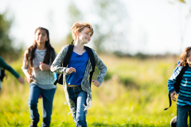 istock Multi-Ethnic Youth Running Through a Field stock photo 1203476247