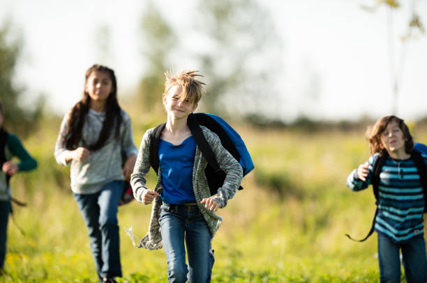 istock Multi-Ethnic Youth Running Through a Field stock photo 1203476268