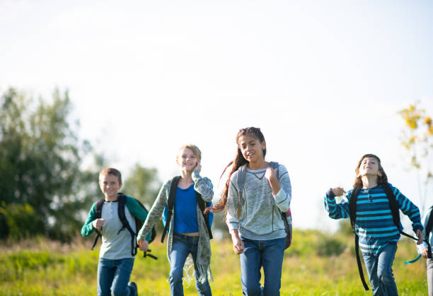 istock Multi-Ethnic Youth Running Through a Field stock photo 1203476293