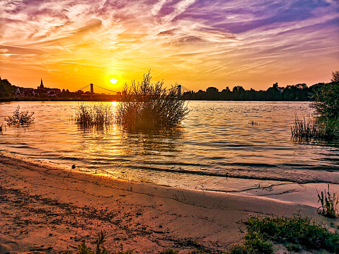 Sundown at the riverside of the river Rhein in Cologne summer sand Beach